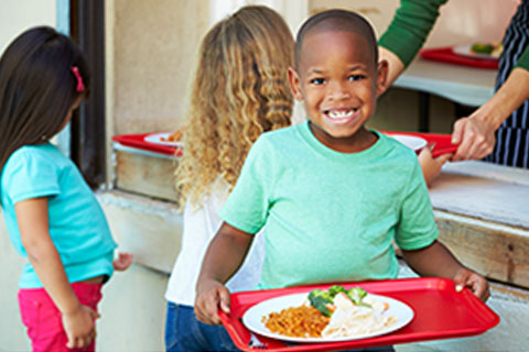 Child with tray of food