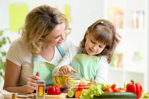 Child and mother cooking